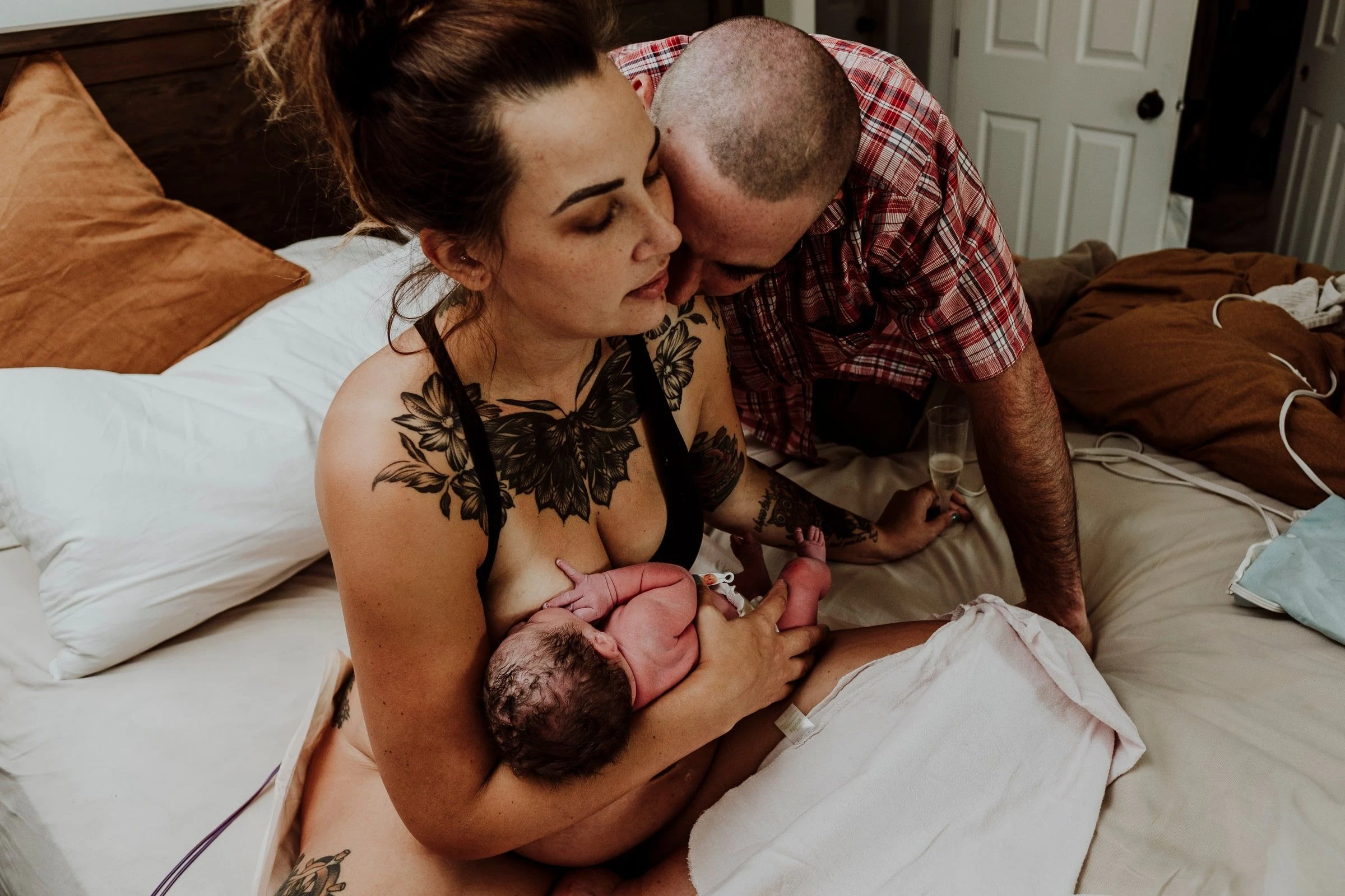 A doula and birth photographer supporting a labouring person in a hospital room