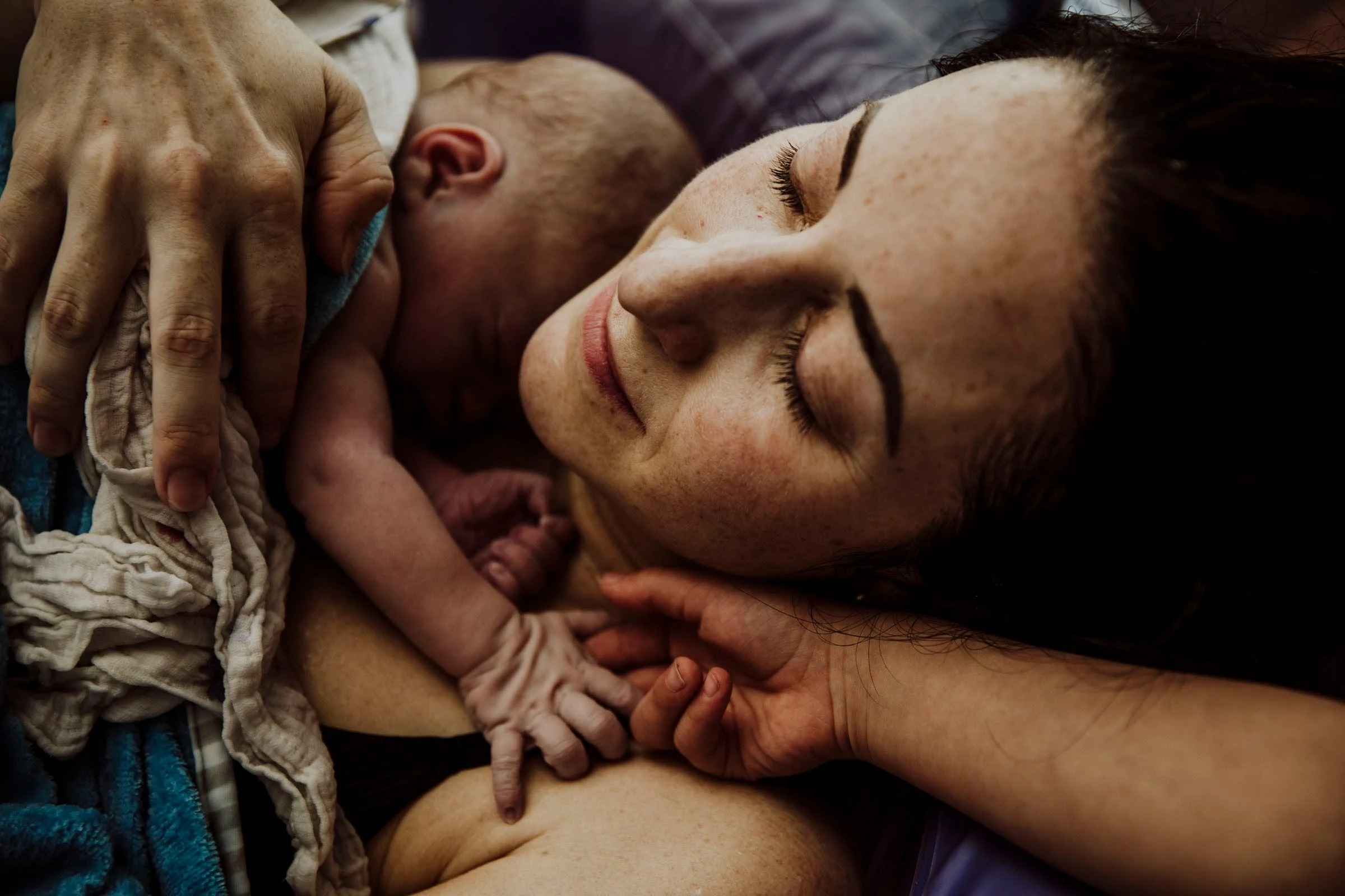 Kelowna birth doula and photographer Krista Evans with a mother holding her newborn baby